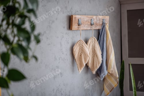 Preview: Macrame leaves hangs on a gray plain background. Handmade hobby. Decoration in Boho style.