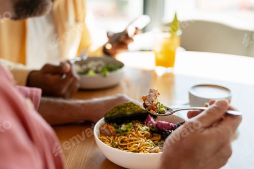Preview: People enjoying Asian noodles, eating lunch at restaurant