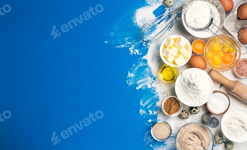 Preview: Baking ingredients on blue color background, top view
