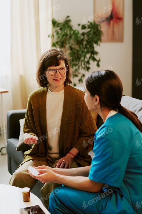 Preview: Senior Woman Receiving Medical Consultation at Home