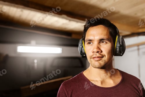 Preview: Portrait of man wearing ear muffs