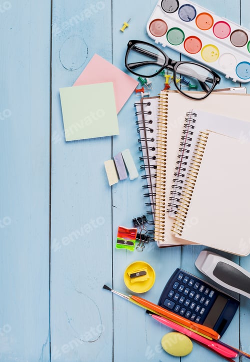 Preview: Colorful study materials and supplies arranged on a blue wooden table for creative learning and
