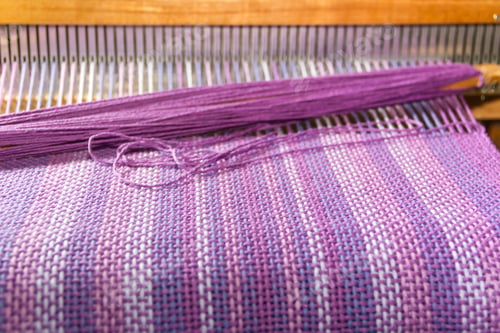 Preview: close up weaving of cotton threads on comb loom