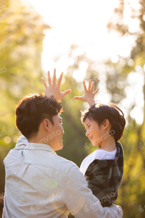 Preview: Happy Chinese father and son relaxing in park