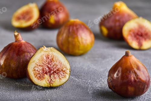 Preview: Fresh figs whole and cut into pieces on a gray background, the concept of a healthy