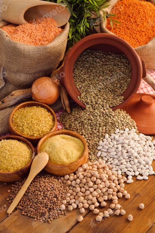 Preview: bowls of legumes, lentils, chickpeas, rice and beans on wooden table