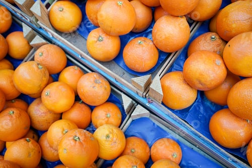 Preview: Top shot of fresh oranges in baskets for sale