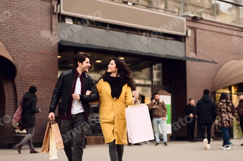 Preview: Satisfied couple shopping together in city mall