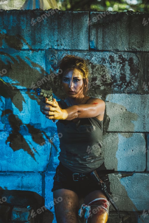 Preview: A Woman Leaning Against a Wall with a Gun