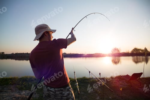 Preview: Fishing as recreation and sports displayed by fisherman at lake