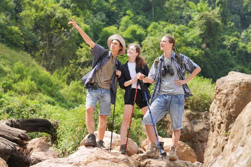 Preview: Hikers walking along a trail on a mountain with hiking sticks