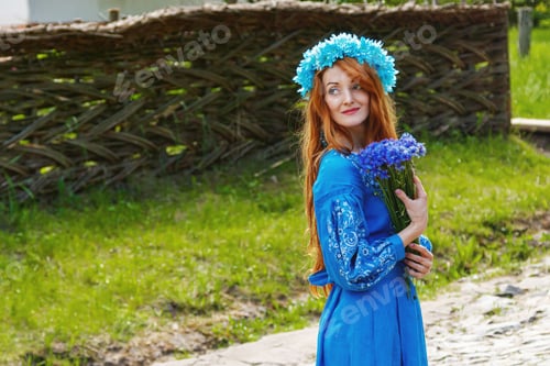 Preview: Beautiful red-haired girl in a blue dress (Ukrainian) with a wreath on her head