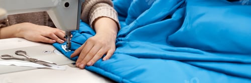 Preview: Sewing Machine Close-Up on Blue Fabric Wide Banner