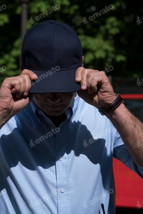 Preview: Adult man in blue cap?outside