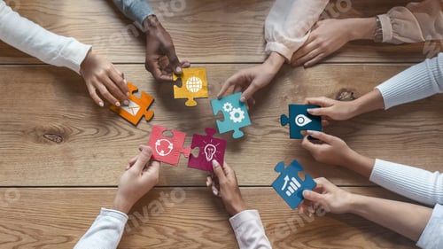 Preview: International team of coworkers putting colorful puzzles together