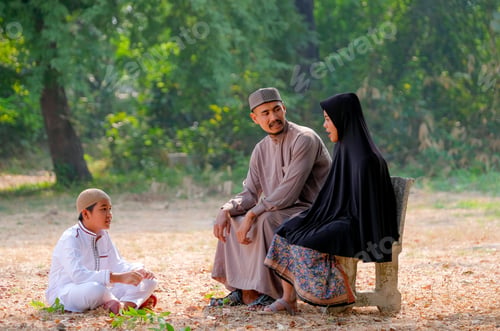 Preview: Muslim family with father, mother and son stay near the forest and talk together with day light.
