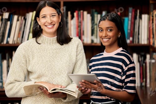 Preview: Shot of two young female students doing research in a library at college