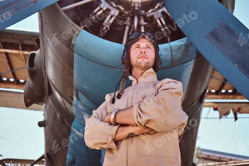 Preview: Proud aviator near jet's propeller.