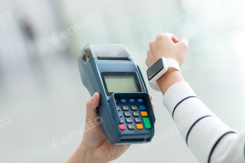 Preview: Woman using smart watch to pay by NFC technology
