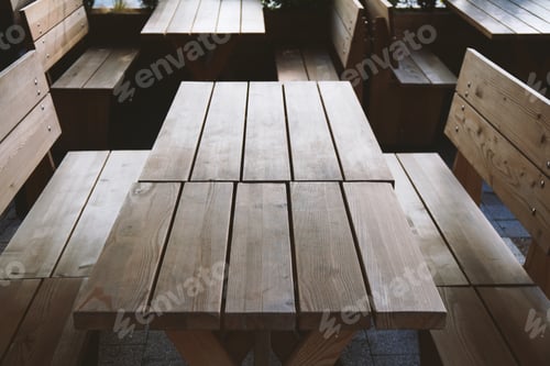 Preview: empty tables and benches at deserted beergarden outdoor restaurant