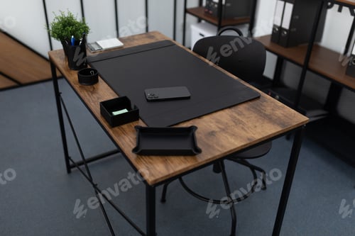 Preview: office desk with office supplies in an empty office
