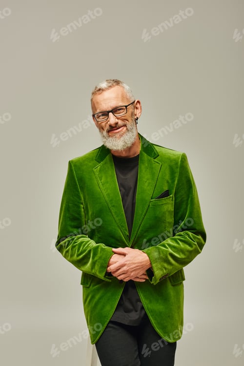 Preview: jolly handsome mature male model in bright outfit with accessories smiling happily at camera