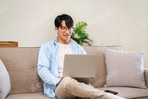 Preview: Businessman in casual is sitting on comfortable sofa and wearing