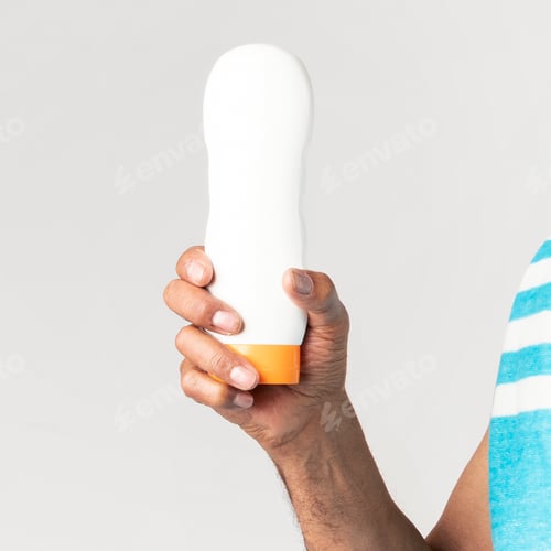 Preview: Senior African American man holding a sunscreen lotion bottle