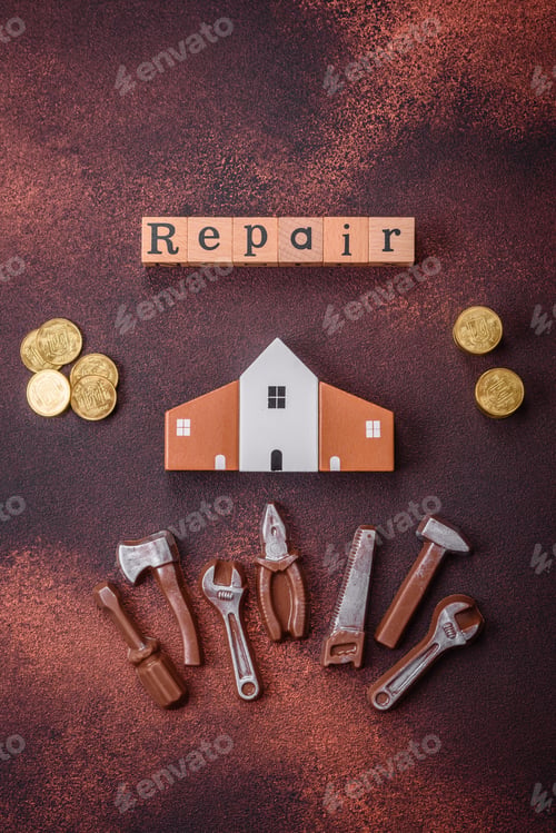 Preview: Repair or home improvement tools and a house model on a plain background