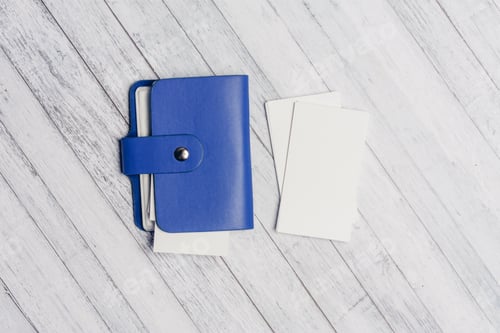 Preview: business card holder with letterheads on a wooden table top view Copy Space