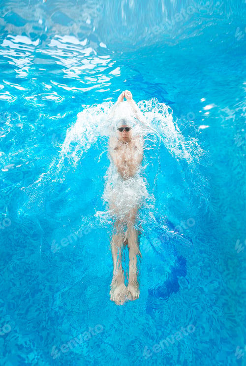 Preview: athlete man swimming on back at pool