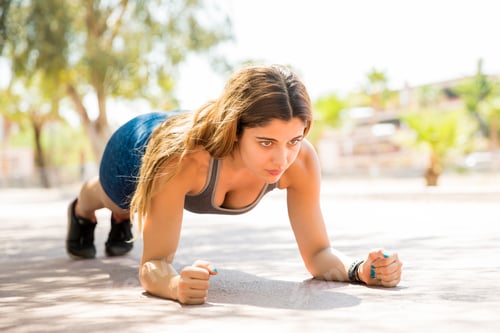 Preview: Fitness woman doing planks at park
