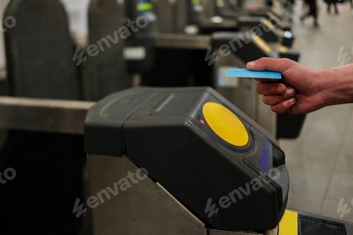 Preview: Commuter using contactless payment at subway station turnstile