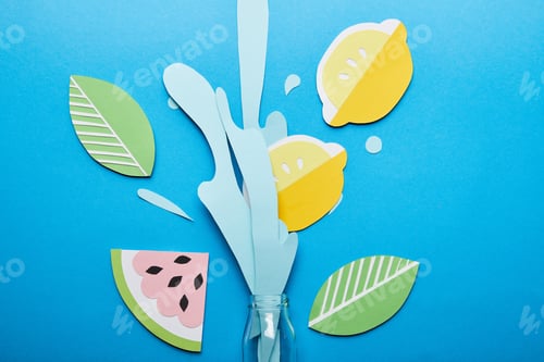 Preview: top view of bottle with paper cut water splash, lemons, leaves and watermelon on blue background