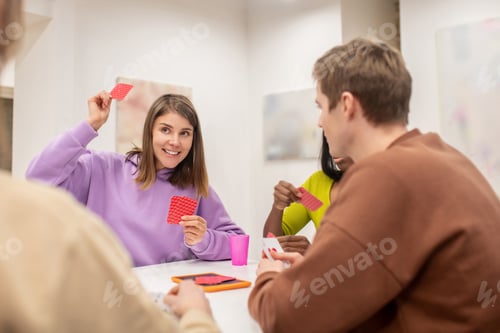 Preview: Friends sitting at the table and playing cards