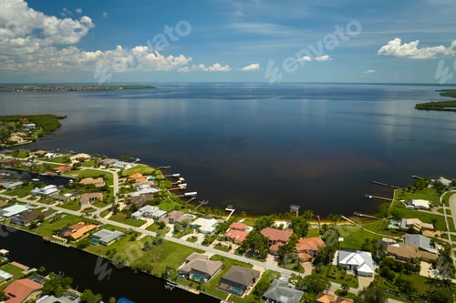 Preview: Aerial view of residential suburbs with one storey houses located near wildlife wetlands