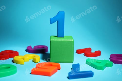 Preview: Number One among fallen magnets on light blue background