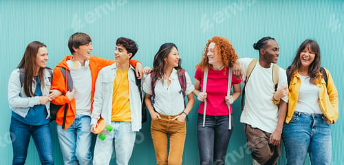 Preview: Diverse young people standing together in front of blue wall