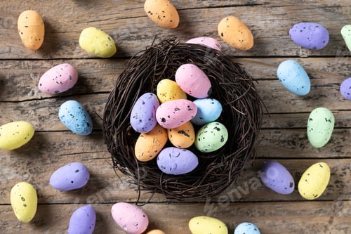 Preview: Colorful Easter eggs inside a nest on wooden table