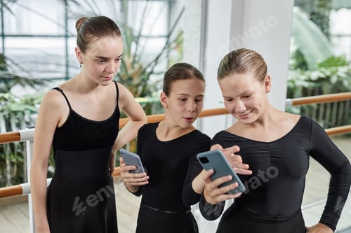 Preview: Three Ballet Dancers Having Fun while Using Phones after Exercising Indoors