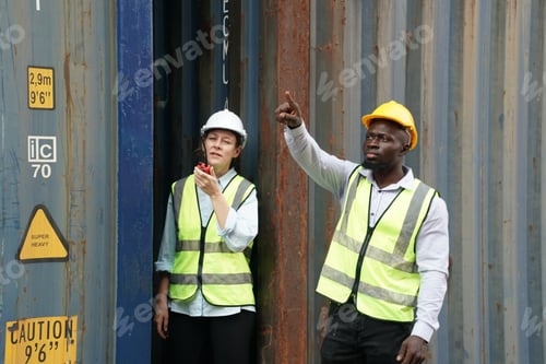 Preview: Foreman control loading Containers box from Cargo freight ship for import export.