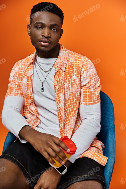 Preview: Stylish Young Man Rests on Modern Blue Chair