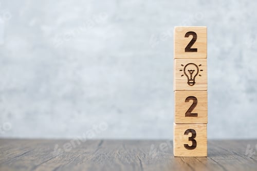 Preview: Wooden Blocks Stacked Showing 2023 with Lightbulb Icon