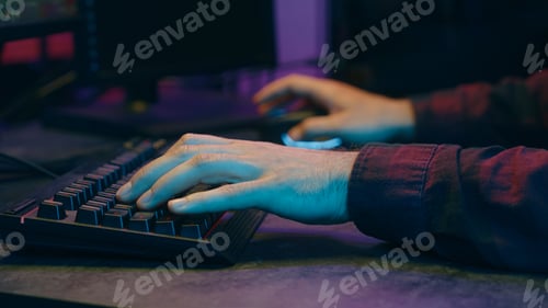 Preview: Carefree Caucasian gamer guy blogger vlogger man playing computer game at home neon night cyber