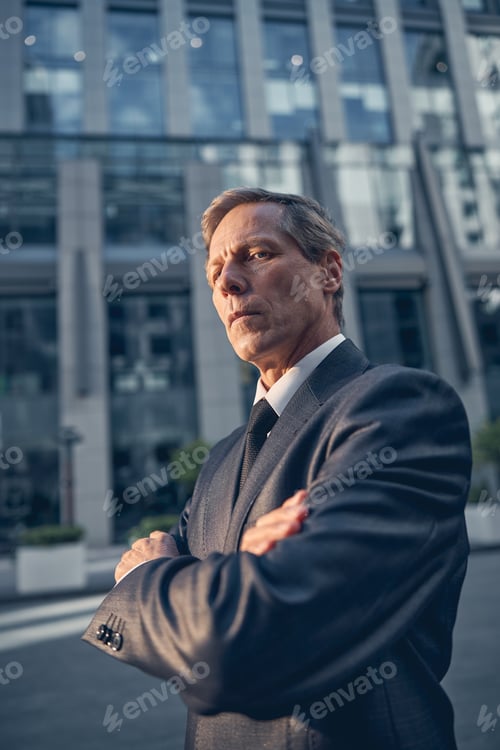 Preview: God-looking man in suit standing on the street