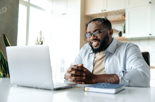 Preview: Man Smiling During Video Call From Home Office
