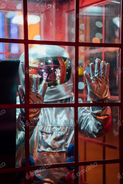 Preview: Spaceman trapped in a telephone box at night