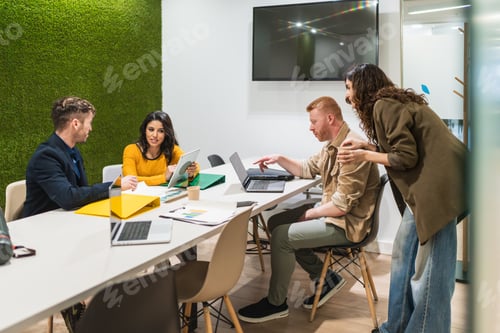 Preview: Young professionals collaborating on project in modern coworking space