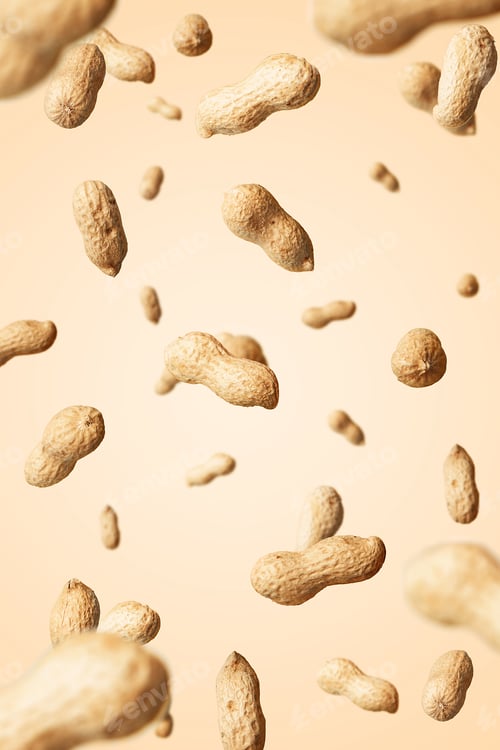 Preview: Levitation of raw peanuts on beige background.