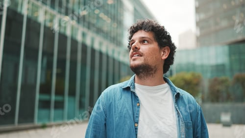 Preview: Close-up, man in denim shirt walks down the street, stops and looks around
